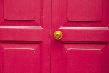 Door knob golden color with pink, door background