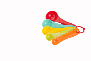 colorful measuring spoons isolated on white