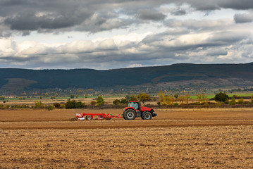 Tractor plowing a field at dusk