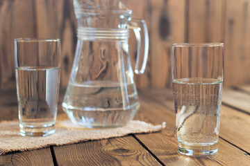 Glasses of water on a wooden table