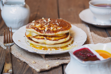 Pancakes with walnuts and syrup for breakfast