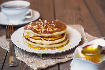 Pancakes with walnuts and syrup for breakfast