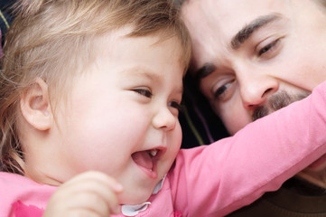 cheerful kid and daddy having fun laughting very emotional