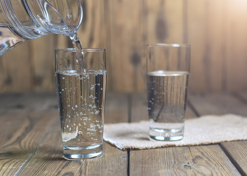 Glasses of water on a wooden table