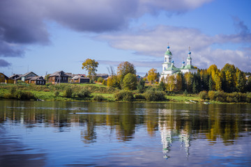 Russian village. Church near the river.