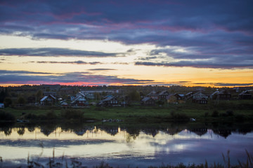 Fototapeta na wymiar Russian village. Sunset over the river