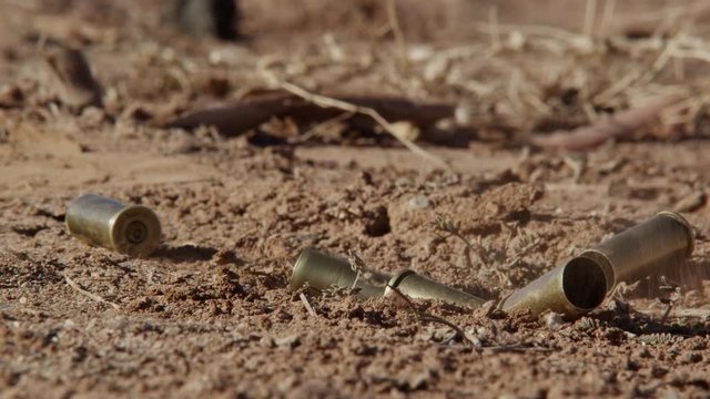 Bullet shell casing falling on the dirt