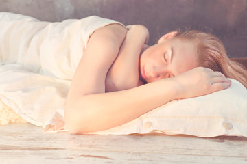 morning light illuminates woman sleeping in bed - obrazy, fototapety, plakaty