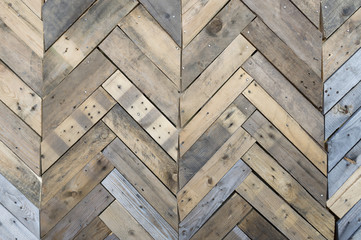 Weathered wood wall background fitted with parquet pattern