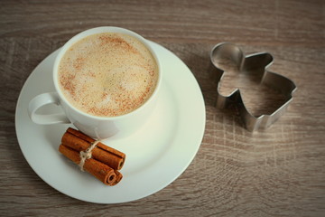 Cup of coffee with cinnamon and little angel 