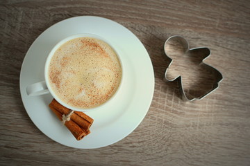 Cup of coffee with cinnamon and little angel 