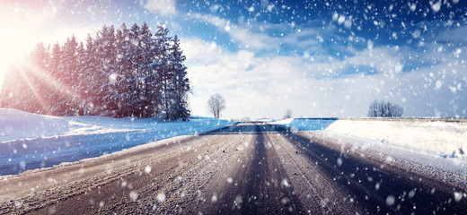 Fototapeta na wymiar Car on winter road covered with snow