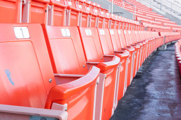 Empty orange seats at stadium,Rows of seat on a soccer stadium