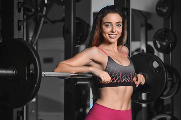 Fototapeta na wymiar Beautiful fitness woman trains in the gym.