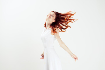 Woman in white dress jumping dancing