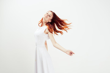 Woman in white dress jumping dancing