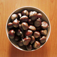 Close-up detail shot of plate plenty of brown chestnuts