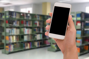 hand holding phone isolate on library background