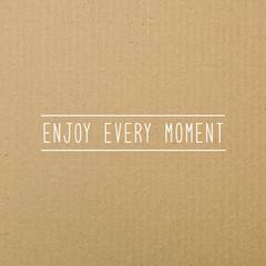 Enjoy every moment on brown paper.