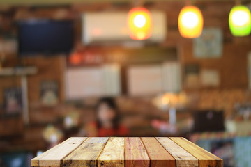 Empty wood table top with coffee shop blur with bokeh background. For product display