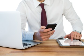 Mid-section of businessman using mobile phone 