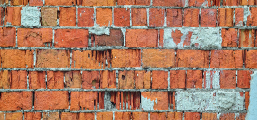 Red brick wall texture. Time dilapidated brick wall with old plaster elements