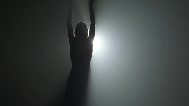 Silhouette of a dancing young woman 
