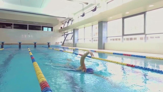 Professional female swimmer training in swimming pool
