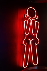 A picture sign of the girl sitting using for restroom, bathroom or others meaning that represent women