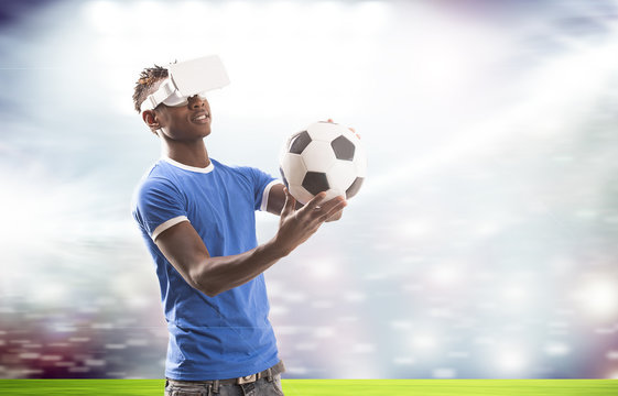 Young man with virtual reality headset or 3d glasses over football field on stadium background 