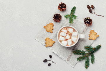 Cup of hot cocoa or chocolate with marshmallow and cookies on white table from above. Traditional winter drink. Flat lay.
