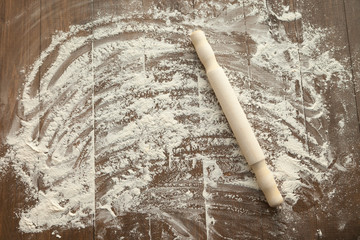 Scattered flour on wooden table.