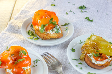 Bruschetta with cherry tomatoes, sweet pepper, mozzarella cheese and marjoram