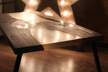 Obraz premium Wood and epoxy table with star lamp in wooden interior