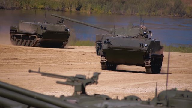 Two Btr-D and self-propelled anti-tank gun "Sprut-SD" moving on a dirt road on military exercises. Includes audio. Contains audio