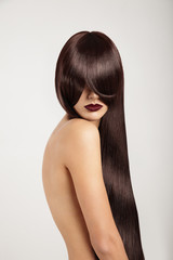 Fototapeta premium woman with a long straight hair covered her face but shows beuty