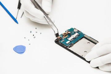 technician repairing broken mobile phone
