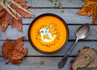 Pumpkin soup a wooden table.