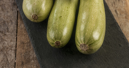 Fresh zucchini on wooden background