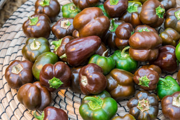 small green and black peppers in a basket