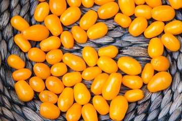 yellow cherry tomato in a basket, food background