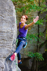 Naklejka na ściany i meble The girl climbs the rock.