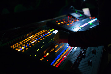 Soundman working on the mixing console.