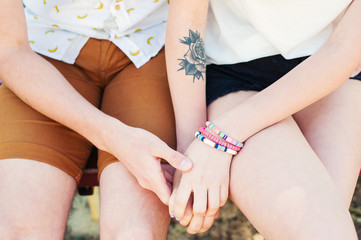 Loving couple men fnd women holding hands in park