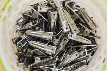 group of silver Clothes peg in white basket
