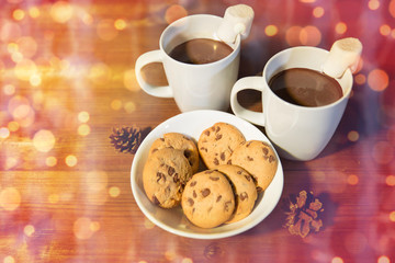 cups of hot chocolate with marshmallow and cookies