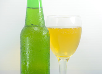 Green Bottle with Condensation and Glass of beer Isolated on white background