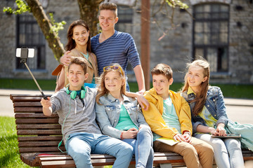 happy teenage students taking selfie by smartphone