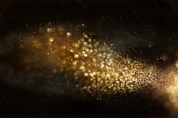 glitter vintage lights background. dark gold and black