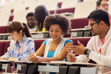group of students with notebooks in lecture hall